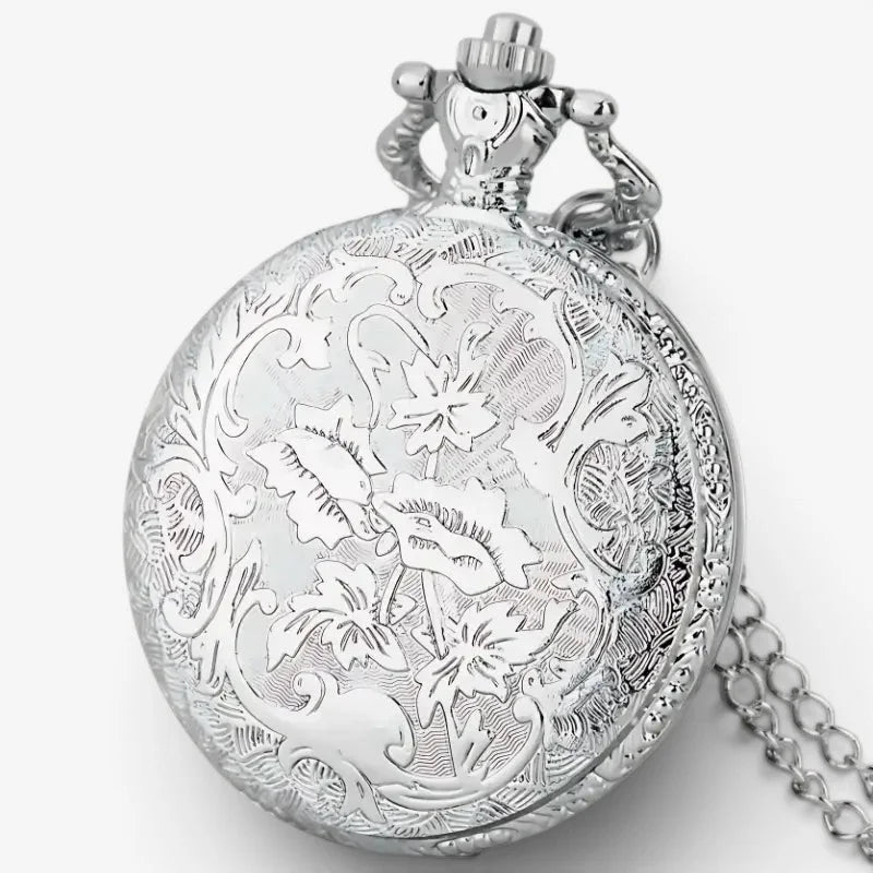 Silver quartz pocket watch necklace with intricate floral engravings and a decorative crown on the front side