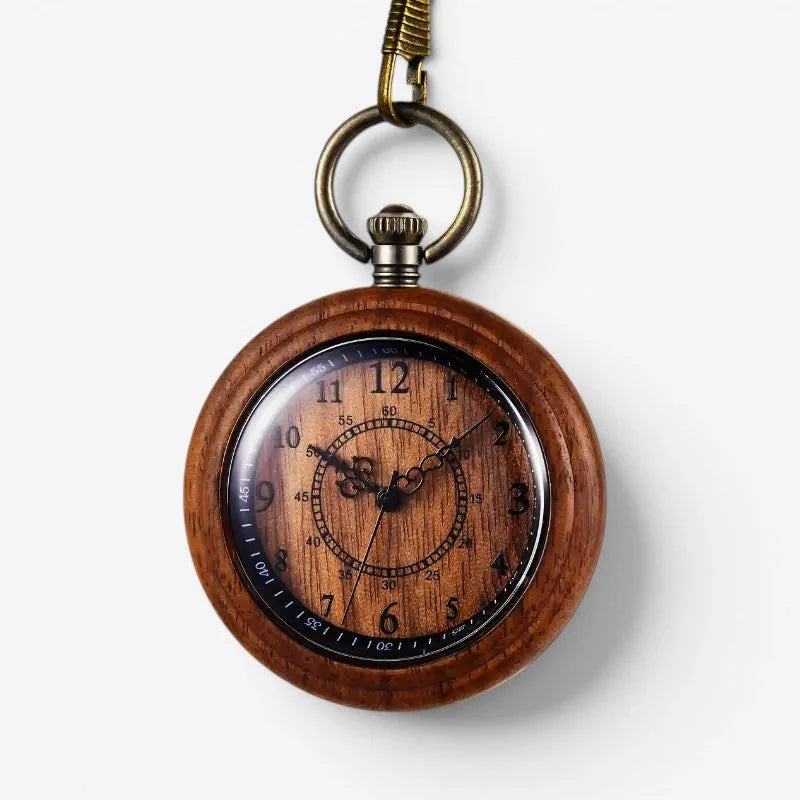 A rustic quartz wood pocket watch with a black dial, white numerals, and brass-colored metal clasp