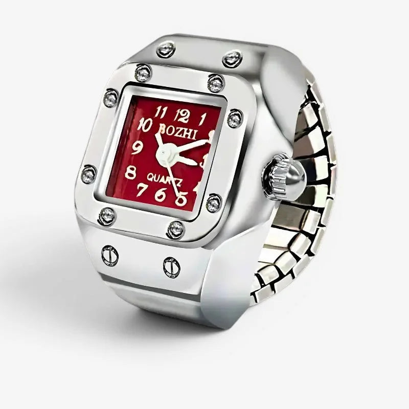 Silver-toned rectangular red ring watch with red face white numerals hands and clear gemstones at case corners