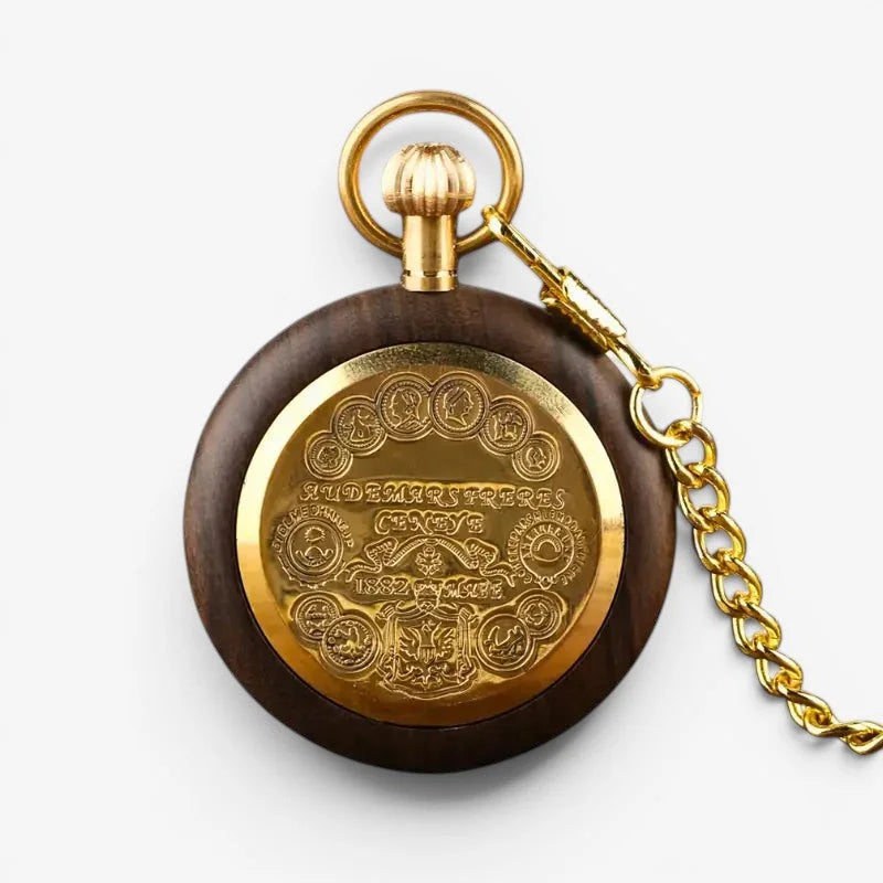 Roman numeral wood pocket watch with dark wood casing and ornate gold-toned engraved backplate showing Audemars Piguet Geneve 1832