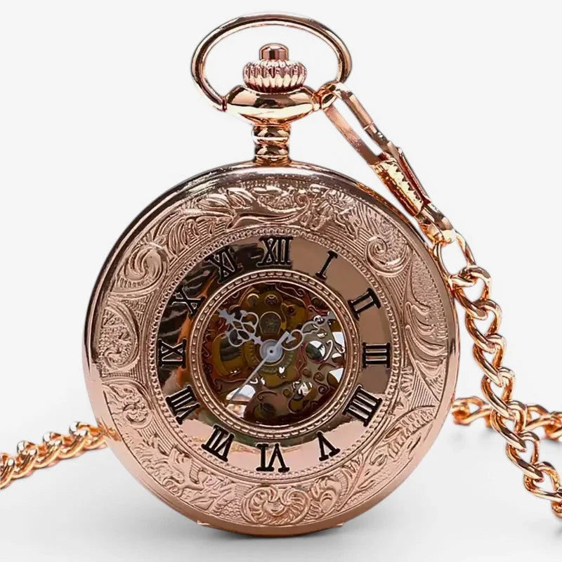 Rose gold roman numeral pocket watch with intricate engraved detailing and visible mechanical movement on the face