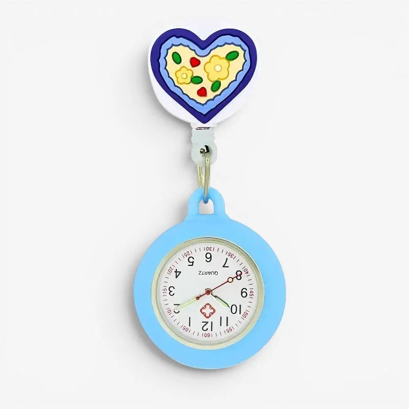 A light blue silicone nurse watch with a round face and heart-shaped clip featuring colorful floral and fruit designs