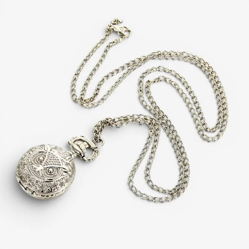Silver owl pocket watch with intricate engraved details and matching chain in polished silver metal design
