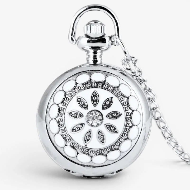 Silver pocket watch necklace with white enamel dial, ornate floral design, clear crystal, and matching chain
