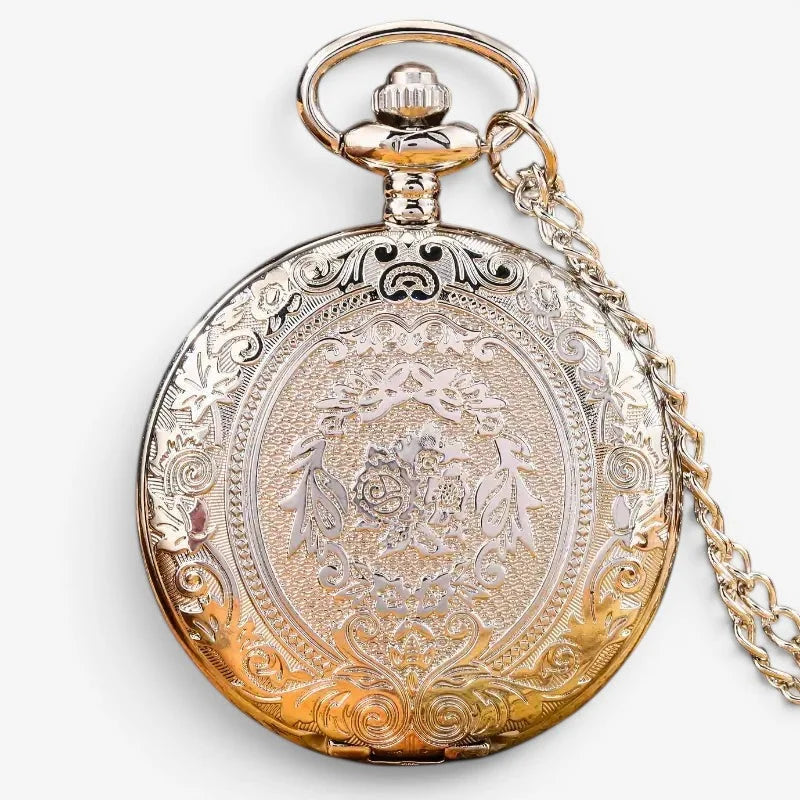 Silver quartz pocket watch with gold-toned antique style, floral engravings, decorative crown, and matching chain