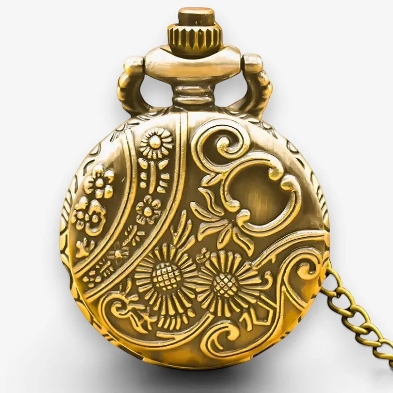 Small pocket watch gold with intricate floral and scrollwork engravings decorative crown top and attached chain