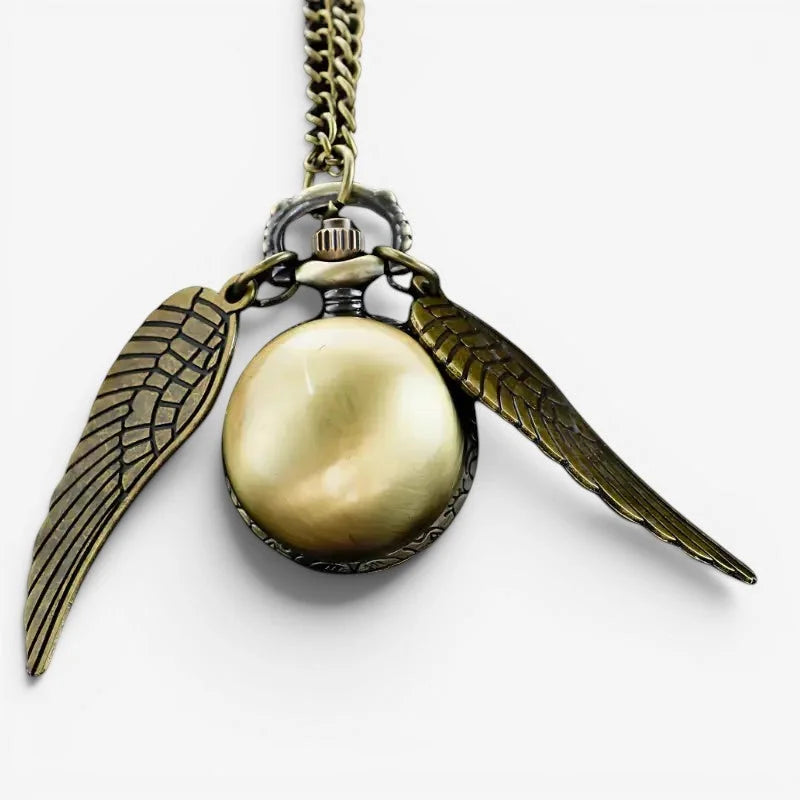 Antique brass-colored snitch ball pocket watch with detailed wing charms hanging from a chain