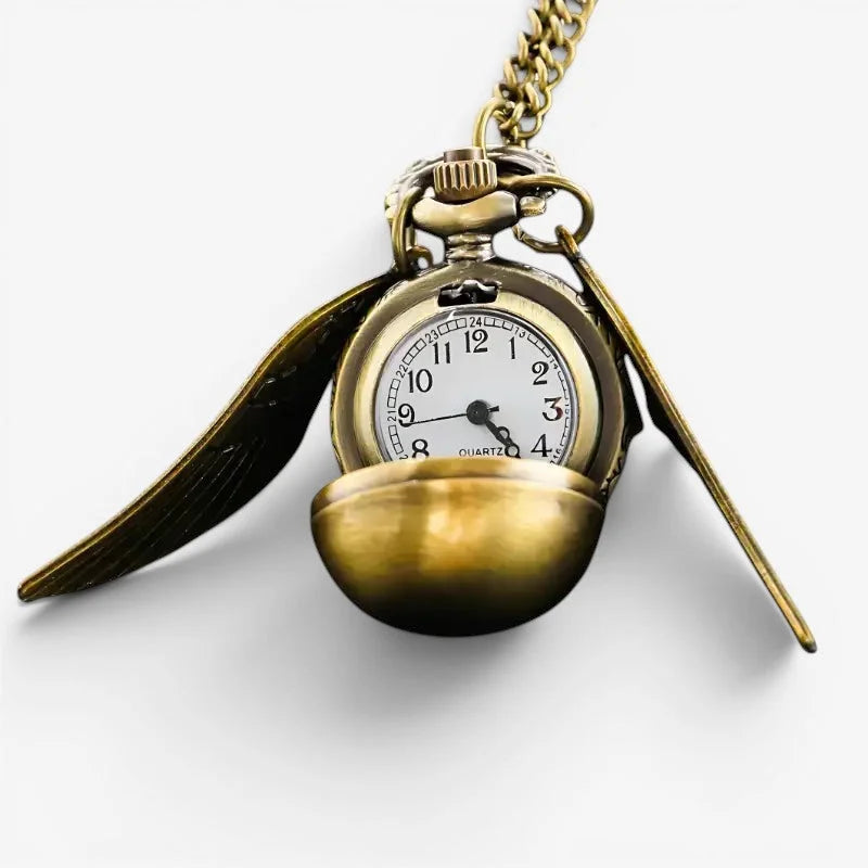 Golden snitch ball pocket watch with winged design white face and black numerals for classic timekeeping