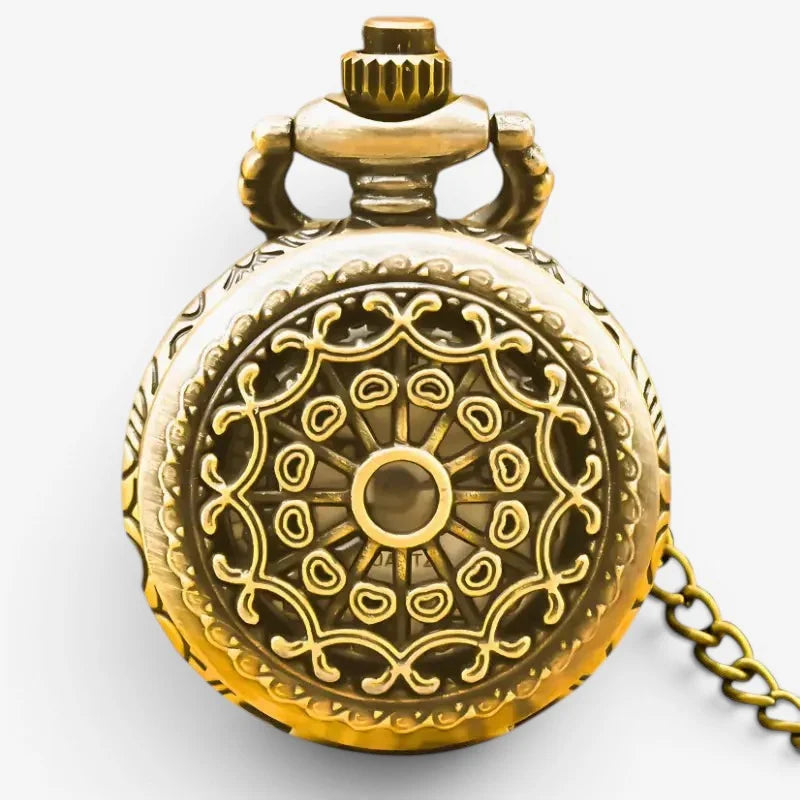 Golden spider web pocket watch with intricate filigree design and matching chain in vintage style