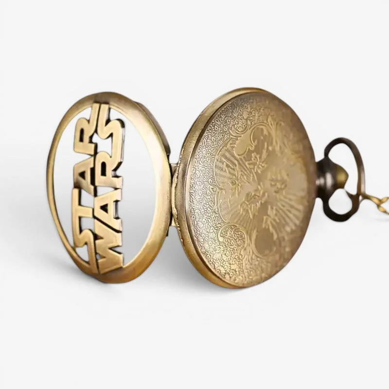Gold-toned star wars pocket watch with circular face, intricate engravings, and star wars logo on outer casing