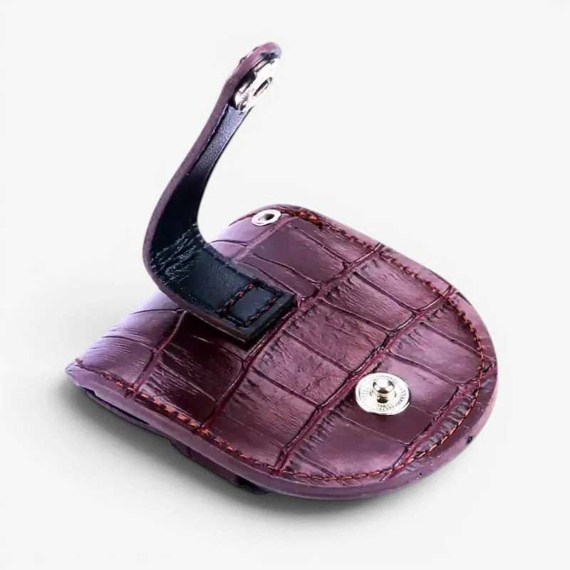 Steampunk pocket watch case with maroon crocodile-patterned leather keychain and black strap with silver clasp