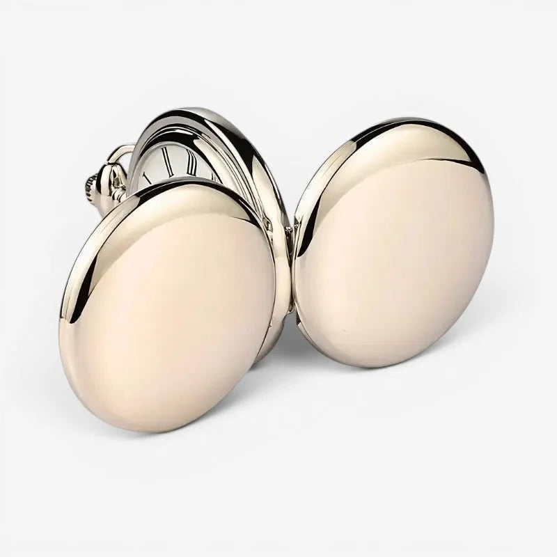 A sleek gold-tone oval sterling silver pocket watch with an open face displaying roman numeral dial