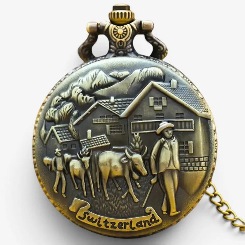 Antique bronze-colored swiss pocket watch with detailed relief of swiss countryside and engraved switzerland on back