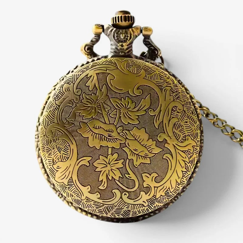 The witcher pocket watch is an antique gold-toned timepiece with intricate floral engravings and a decorative chain