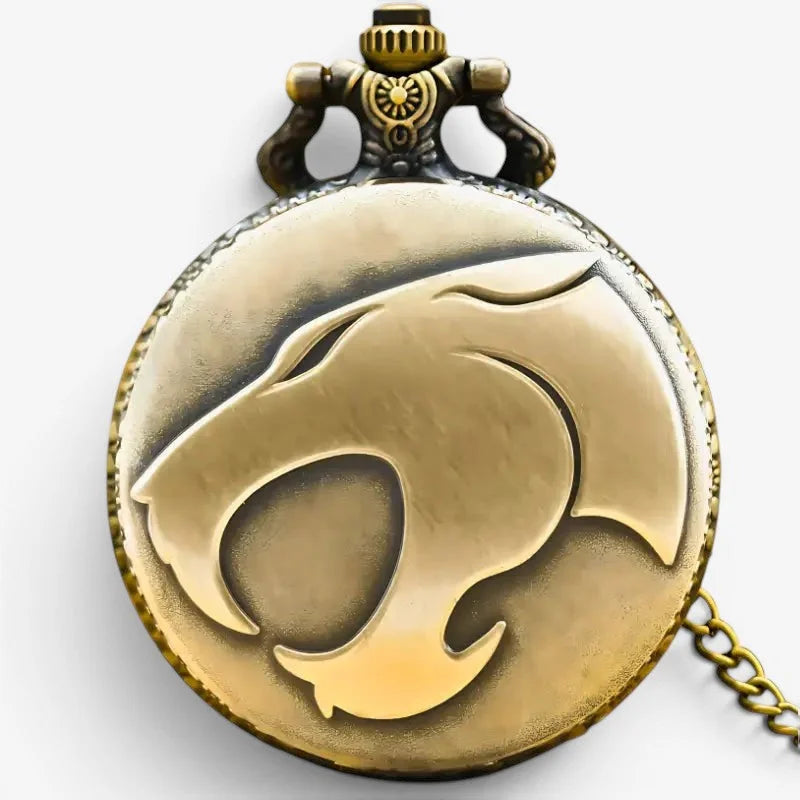 Antique brass-colored brass pocket watch with raised Thundercats logo design on its face for collectors