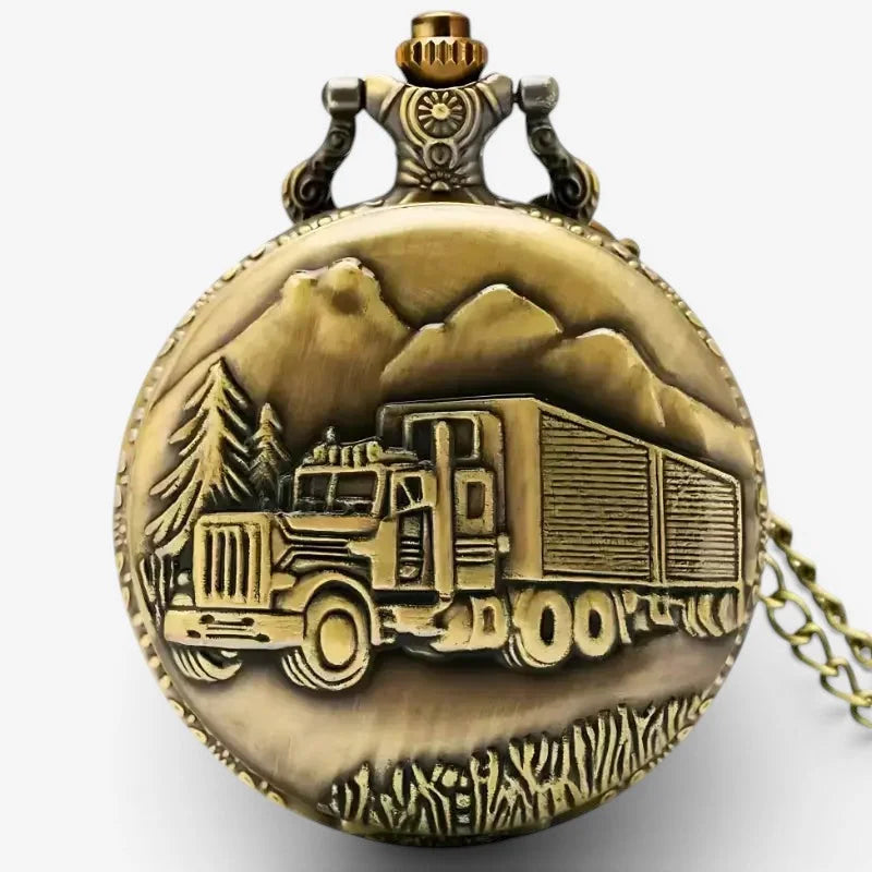 Antique brass truck pocket watch with a detailed relief of a semi-truck driving through mountains and pine trees
