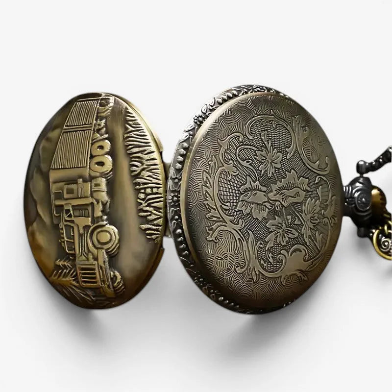 Antique brass truck pocket watch with intricate floral engraving on front and detailed tractor design on back side