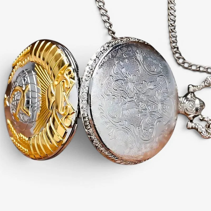 Ornate oval ussr pocket watch locket in gold and silver tones with intricate floral engraving on the inner surface