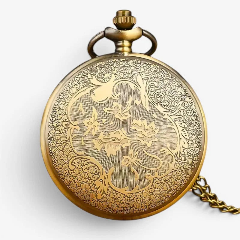 Vintage bronze pocket watch with antique brass finish and intricate floral and scrollwork engraving on circular face