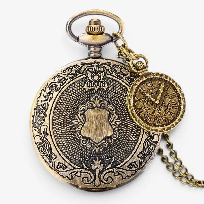 Vintage bronze pocket watch with intricate brass floral and shield engravings, small round clock face, and matching chain