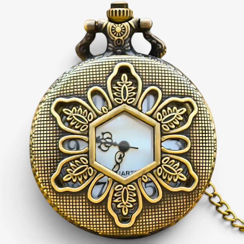 Vintage floral pocket watch in antique brass with intricate floral engraving around a hexagonal face and matching chain