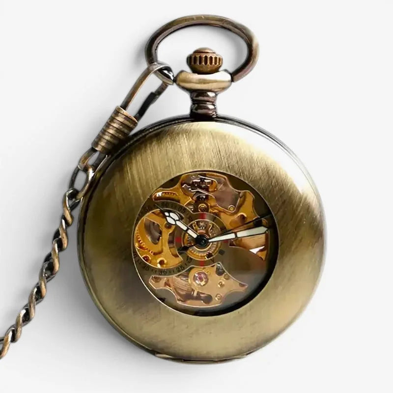 Vintage mechanical pocket watch in antique brass finish with visible internal gears and a winding crown