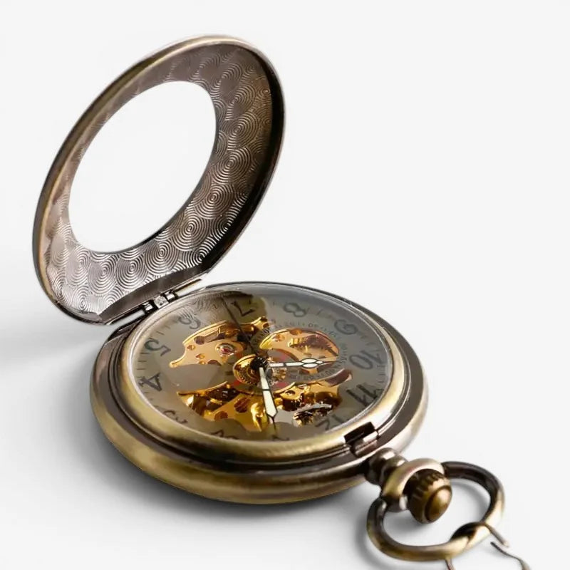 Antique brass vintage mechanical pocket watch with visible mechanical movement and ornate wave patterned inner lid