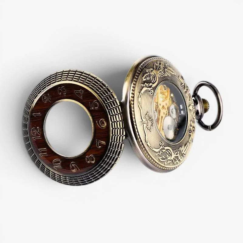 Vintage mechanical wood pocket watch with an ornate engraved brass case and visible mechanical movement
