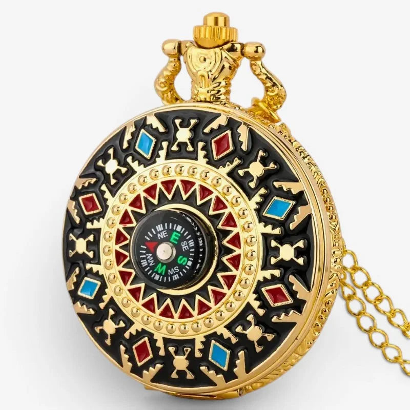 Gold-toned vintage pocket watch compass with intricate black red and blue enamel geometric designs and compass face