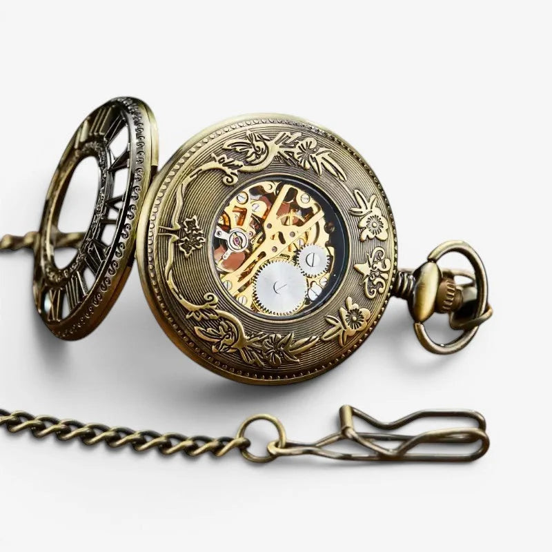 Antique brass visible mechanism pocket watch with intricate floral engravings and visible mechanical gears