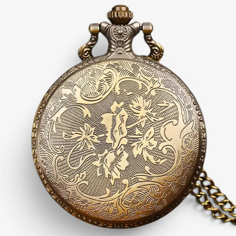Antique brass wolf pocket watch with intricate floral engravings and decorative chain shown from the front
