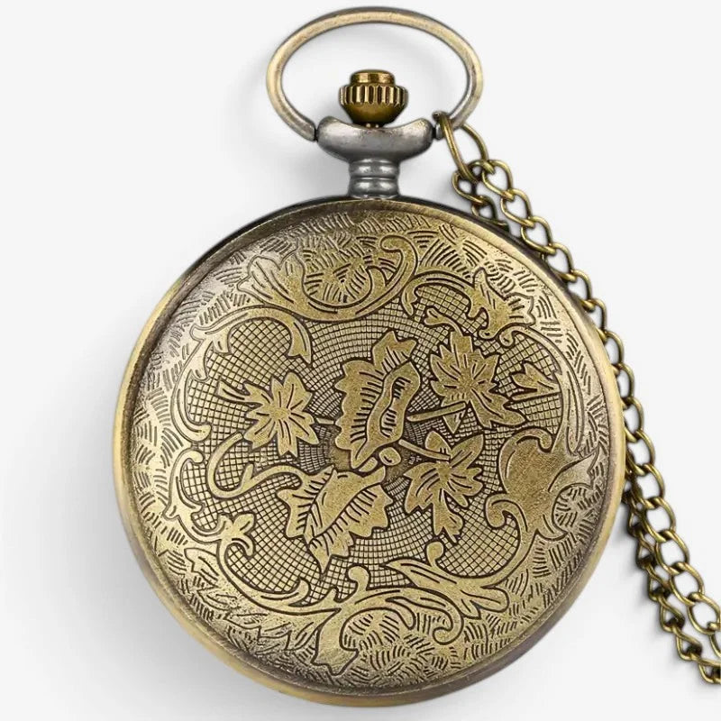 Womens antique pocket watch in brass with intricate floral engravings and matching chain visible in the image