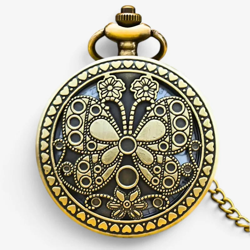 Antique brass womens butterfly pocket watch with intricate butterfly and floral filigree design and decorative chain on dark background