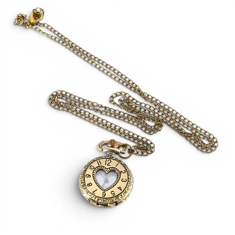 Womens gold-toned heart pocket watch with ornate detailing and adjustable chain suspended for stylish wear