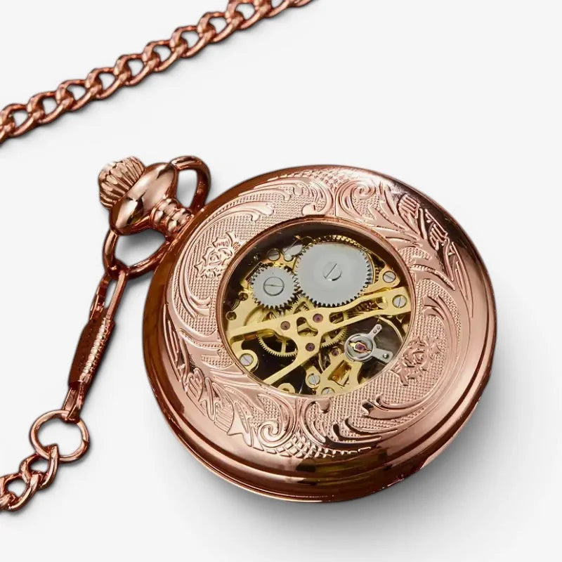 Womens rose gold mechanical pocket watch with intricate floral engraving and visible mechanical gears