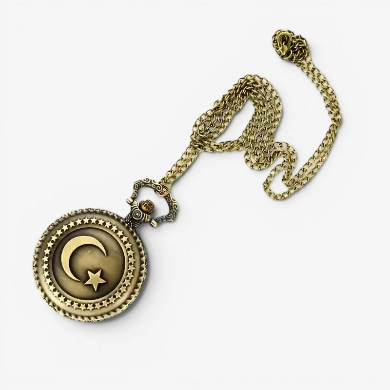 Womens small pocket watch in antique brass with crescent moon star emblem and intricate star patterns on face