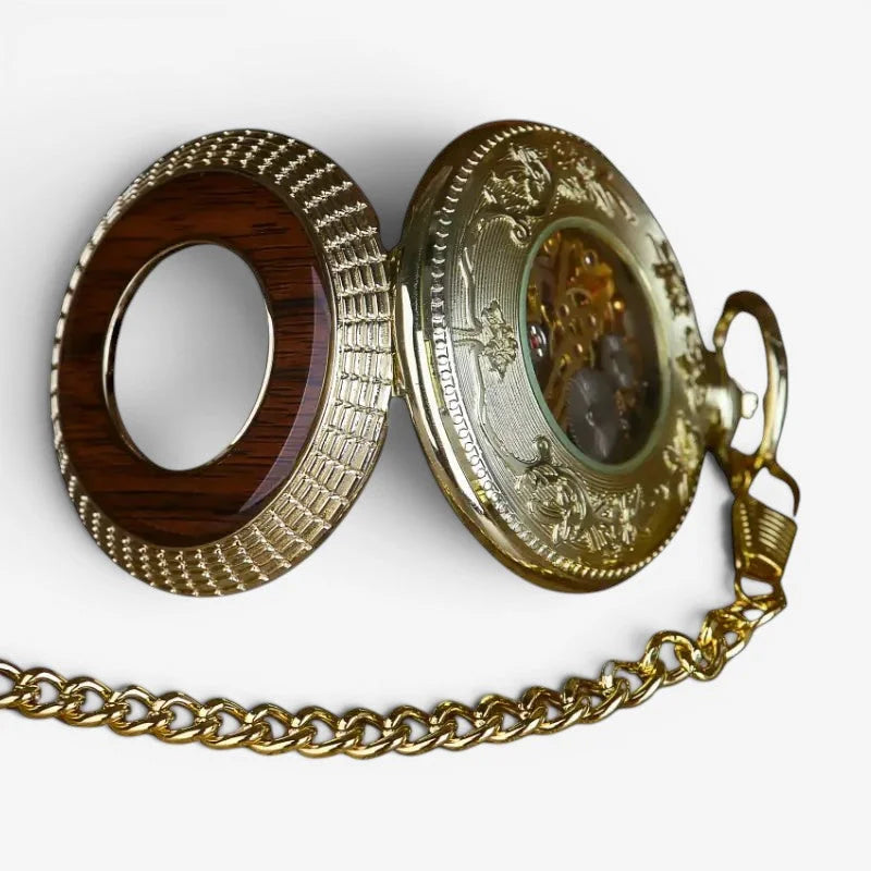 Antique-style gold-toned wood pocket watch with intricate engravings and exposed mechanical movement