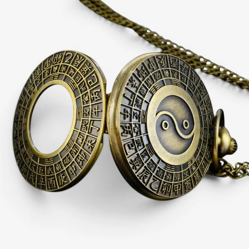 Antique brass yin yang pocket watch with intricate chinese characters and ornate chain for elegant timekeeping
