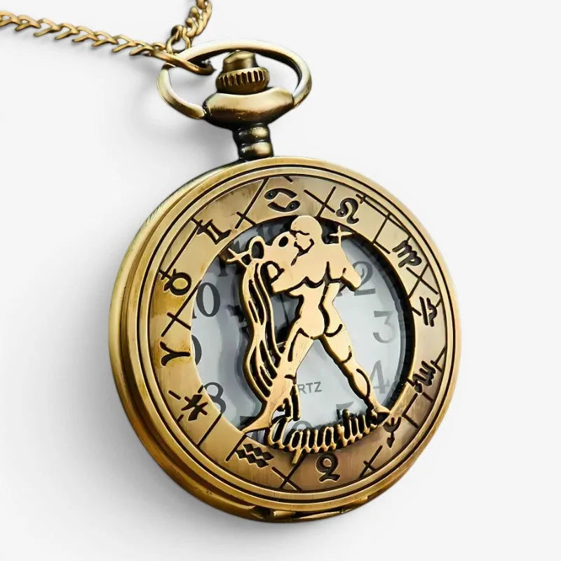 Antique brass-colored zodiac pocket watch with detailed aquarius symbol etching and roman numeral hour markers