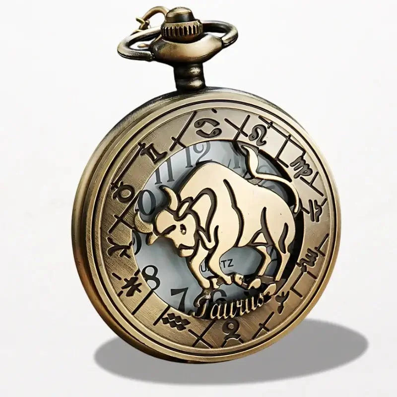 Antique brass-colored zodiac pocket watch featuring a detailed taurus symbol with engraved astrological signs