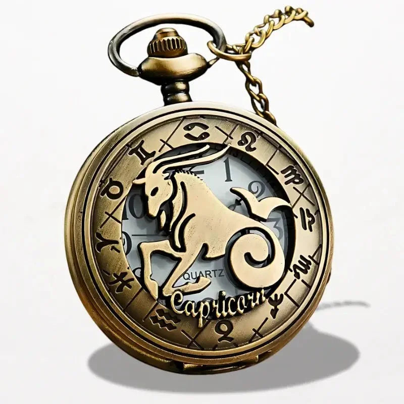 Antique brass-colored zodiac pocket watch featuring a prominent capricorn symbol and engraved astrological signs