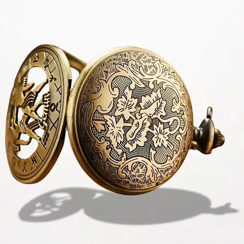Antique brass zodiac pocket watch with intricate floral and scrollwork engraving and detailed cut-out design